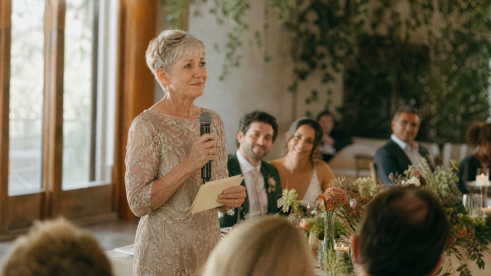 A parent holding cue cards and giving a wedding speech
